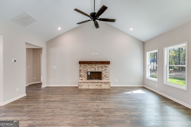 unfurnished living room with high vaulted ceiling, a fireplace, dark hardwood / wood-style floors, and ceiling fan