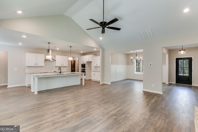 1797 Star Point Rd, Carrollton, GA 30116 - unfurnished living room with a sink, recessed lighting, high vaulted ceiling, wood finished floors, and ceiling fan