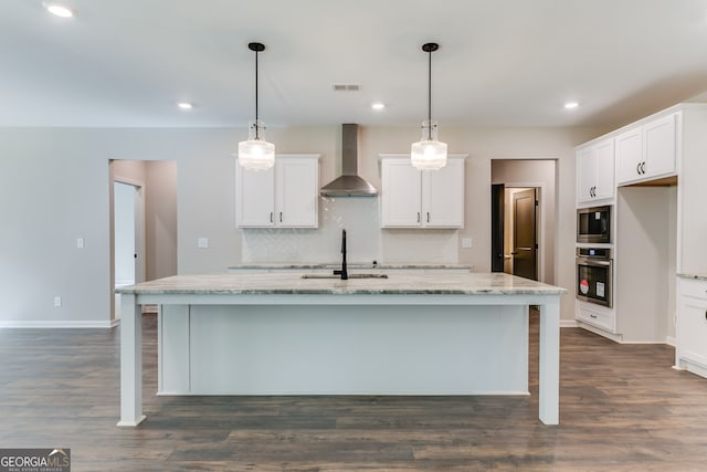 kitchen with sink, white cabinetry, wall chimney range hood, and stainless steel appliances