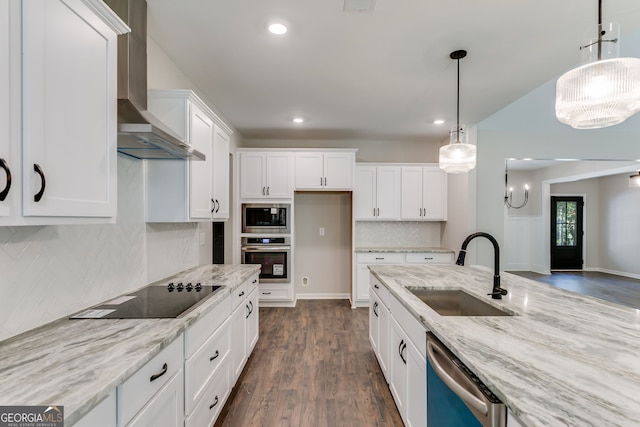 kitchen with wall chimney range hood, sink, appliances with stainless steel finishes, dark hardwood / wood-style flooring, and white cabinets