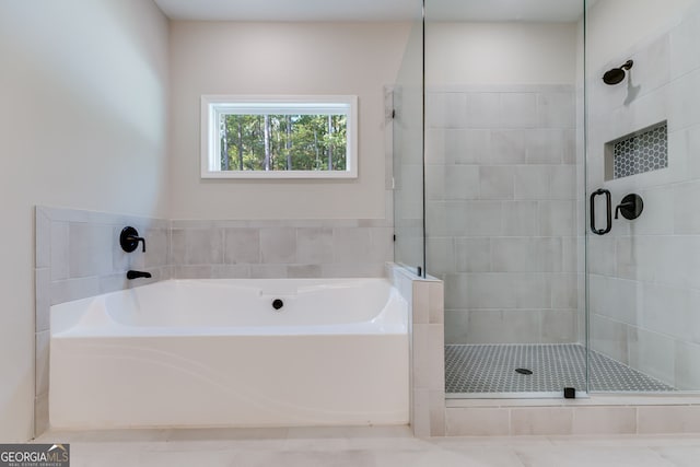 bathroom featuring separate shower and tub