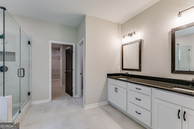 bathroom featuring vanity and a shower with door