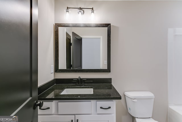 bathroom with vanity, toilet, and a bathtub