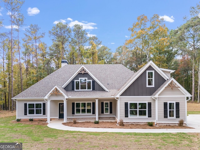 1797 Star Point Rd, Carrollton, GA 30116 - view of front of home featuring a shingled roof, board and batten siding, a chimney, and a front yard