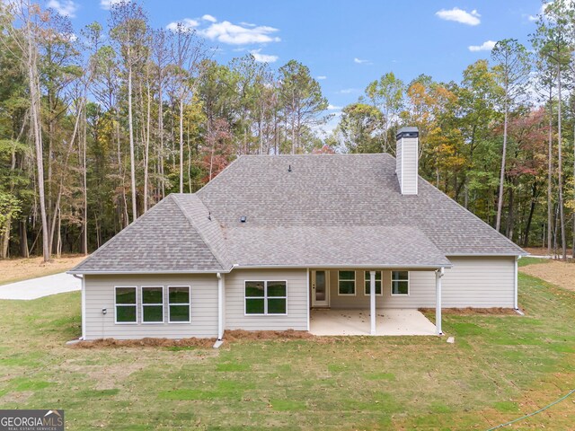 1797 Star Point Rd, Carrollton, GA 30116 - back of property with a patio, a chimney, a yard, and a shingled roof