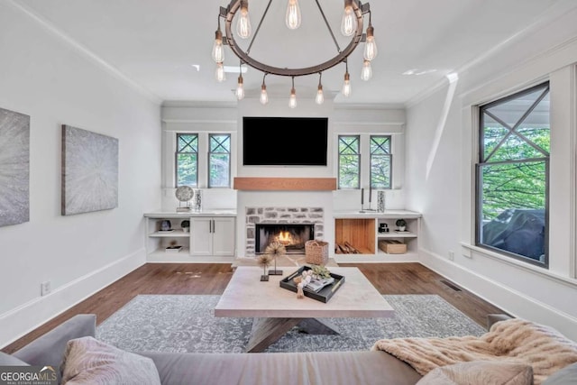 living room featuring plenty of natural light, a fireplace, dark hardwood / wood-style floors, and ornamental molding