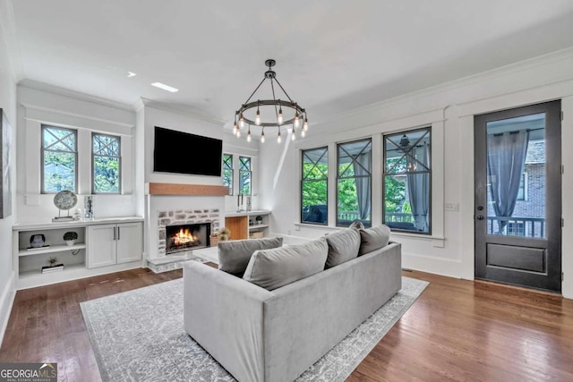 living room featuring dark hardwood / wood-style floors, a chandelier, and plenty of natural light