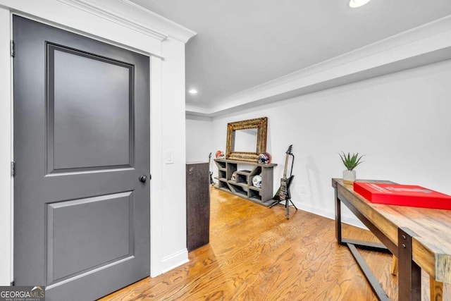 corridor featuring light hardwood / wood-style flooring and ornamental molding