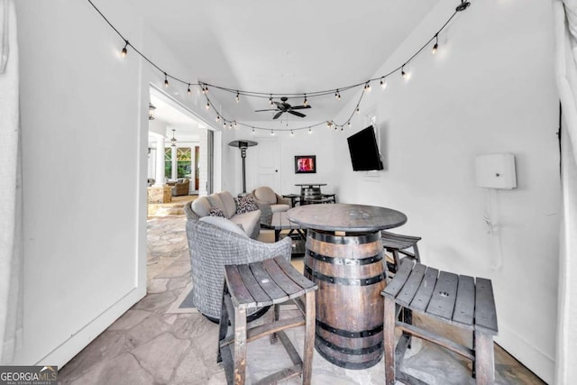 tiled dining space with ceiling fan