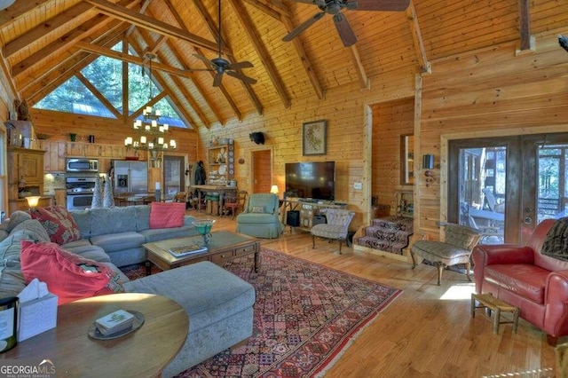 living room with wood ceiling, beam ceiling, wooden walls, high vaulted ceiling, and light wood-type flooring