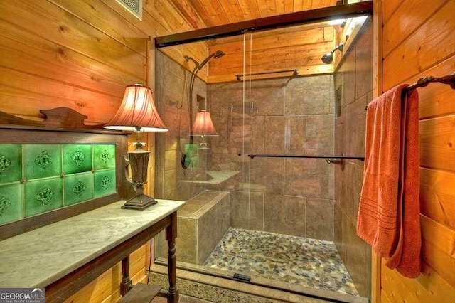 bathroom featuring tiled shower and wooden walls