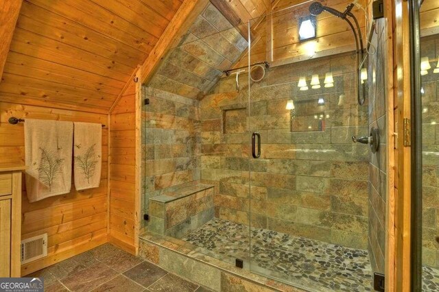 bathroom with walk in shower, wooden walls, wooden ceiling, and vaulted ceiling