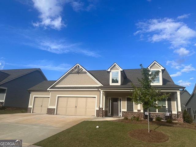 view of front of house with a garage, a porch, and a front lawn