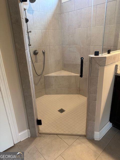 bathroom featuring tile patterned flooring and walk in shower