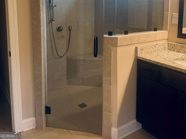 bathroom featuring walk in shower, tile patterned floors, and vanity