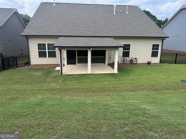 back of house featuring a patio and a lawn