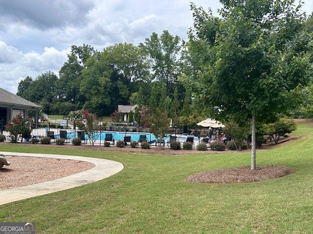 view of community featuring a yard and a swimming pool