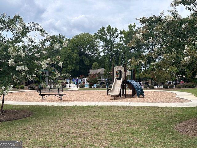 view of jungle gym featuring a lawn