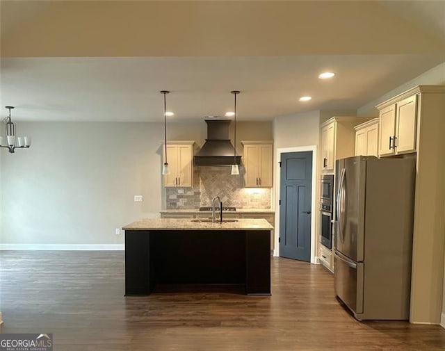 kitchen with dark wood-type flooring, custom exhaust hood, hanging light fixtures, appliances with stainless steel finishes, and backsplash