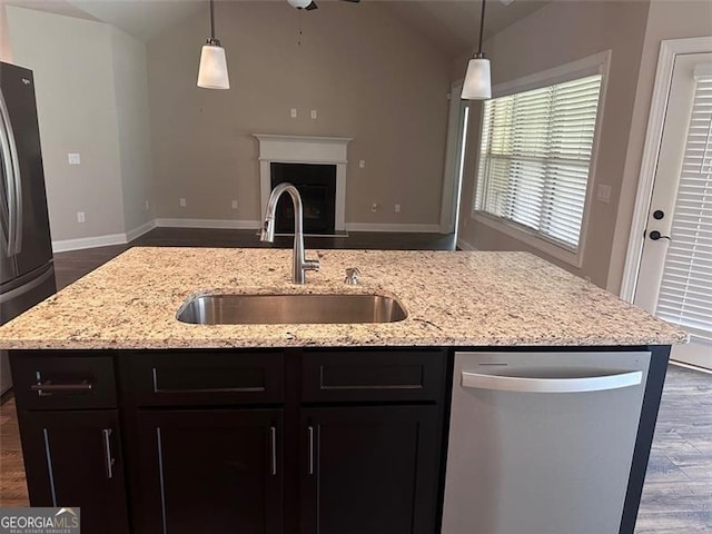 kitchen with fridge, decorative light fixtures, dishwasher, and sink