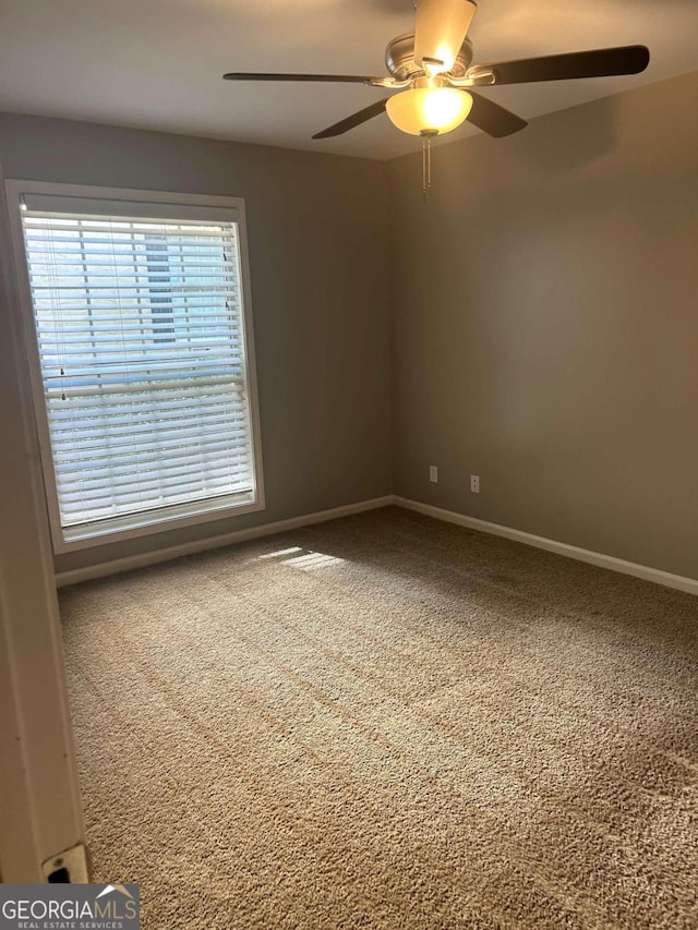 spare room with carpet flooring and ceiling fan