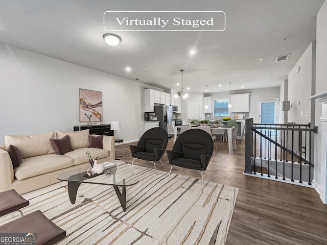 living room featuring a notable chandelier and hardwood / wood-style floors