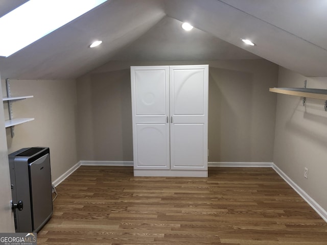 bonus room featuring dark wood-type flooring and lofted ceiling