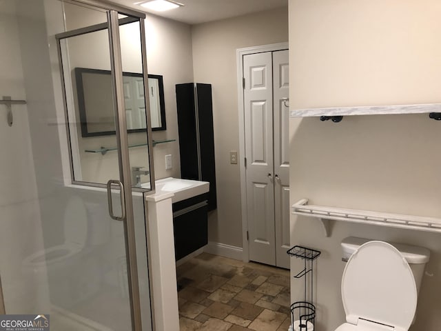 bathroom with vanity, toilet, and walk in shower