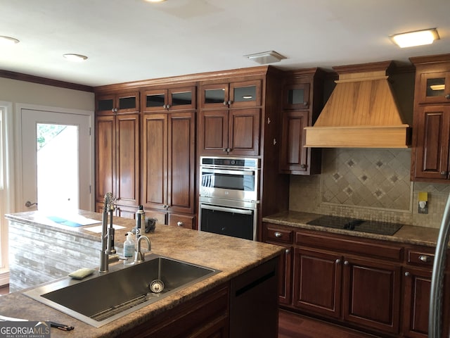 kitchen featuring custom exhaust hood, tasteful backsplash, black electric stovetop, stainless steel double oven, and sink