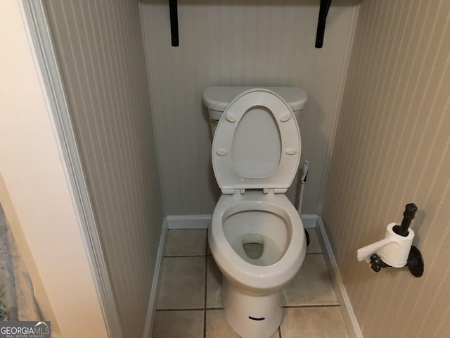 bathroom with toilet and tile patterned flooring