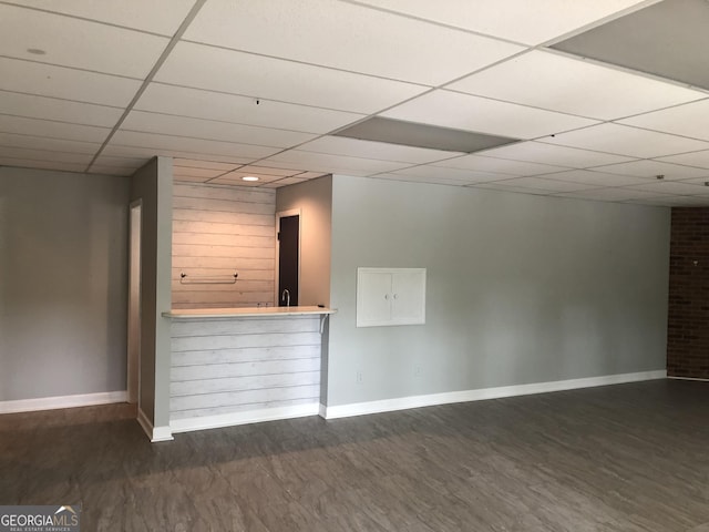 bar with a drop ceiling and dark hardwood / wood-style floors