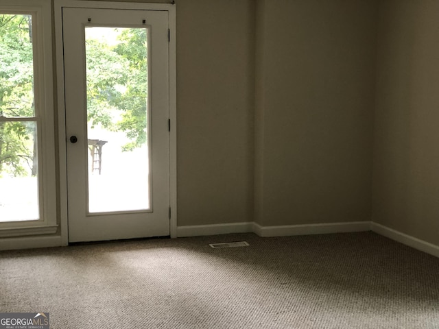 doorway featuring carpet flooring