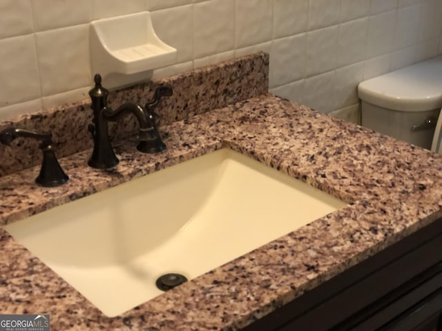 bathroom featuring toilet and vanity