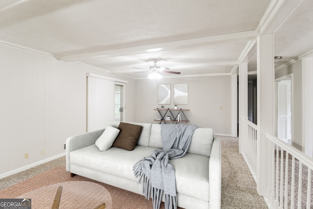 carpeted living room with ceiling fan, ornamental molding, and beamed ceiling