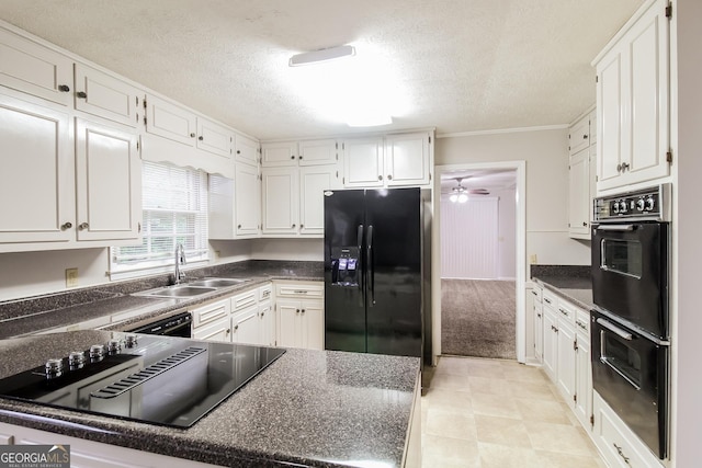 kitchen with ornamental molding, sink, white cabinets, and black appliances