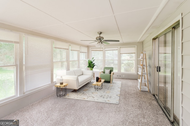 sunroom featuring ceiling fan