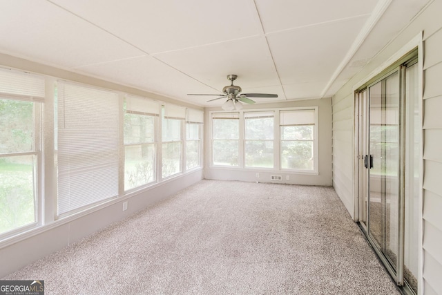 unfurnished sunroom featuring ceiling fan