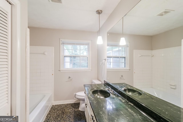 bathroom with toilet, vanity, and tile patterned flooring