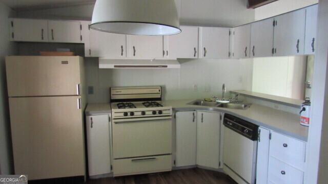 kitchen with sink, white appliances, dark hardwood / wood-style floors, range hood, and white cabinetry