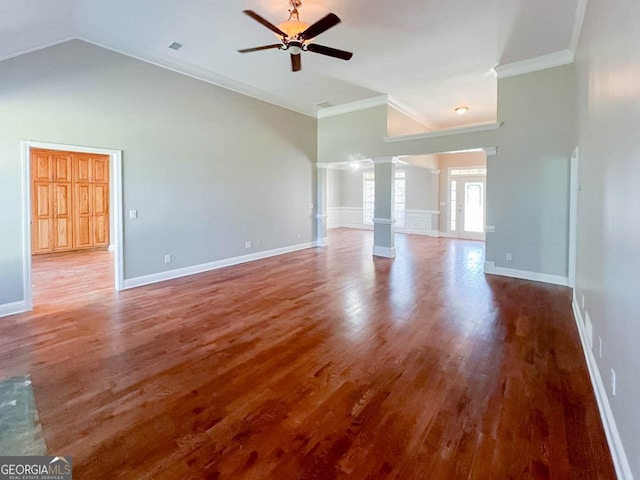 unfurnished living room featuring ceiling fan, high vaulted ceiling, decorative columns, wood-type flooring, and ornamental molding