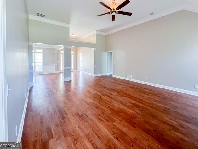 unfurnished room featuring hardwood / wood-style flooring, ceiling fan, ornamental molding, and ornate columns