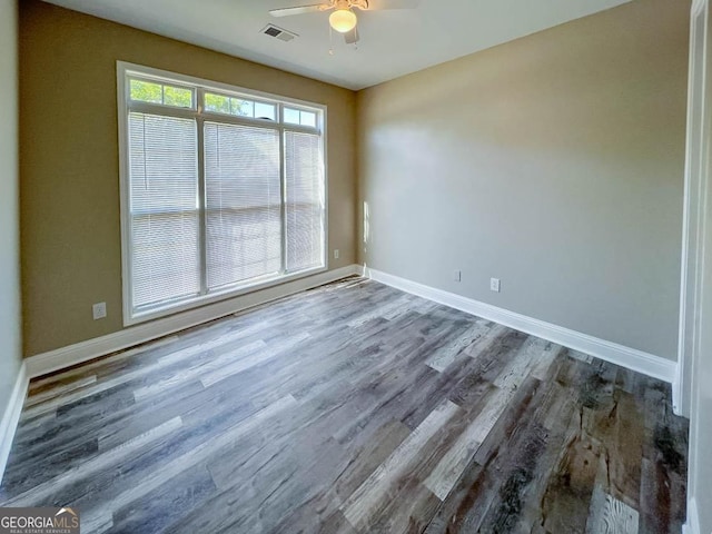 spare room with hardwood / wood-style flooring and ceiling fan