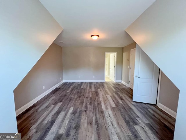 additional living space with dark hardwood / wood-style flooring