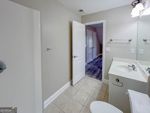 bathroom featuring vanity, tile patterned floors, and toilet