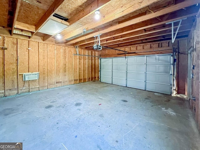 garage with a garage door opener and a wall unit AC