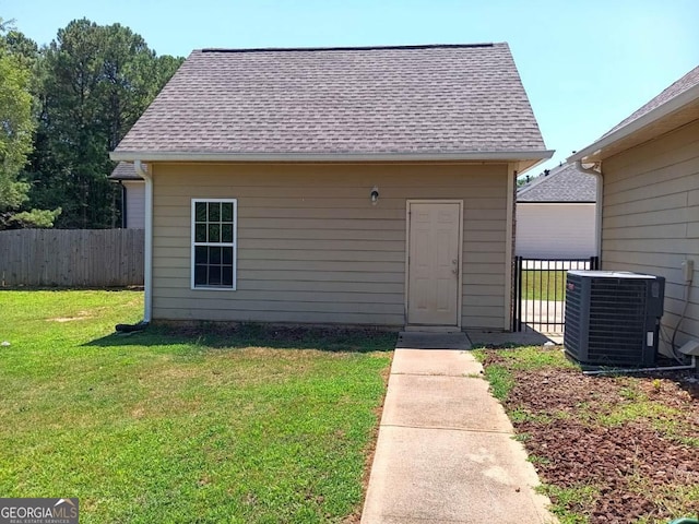 view of outbuilding featuring central AC and a lawn