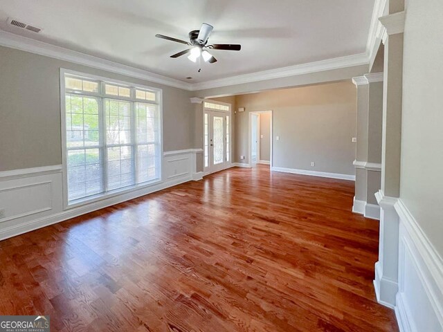 spare room with crown molding, ceiling fan, and wood-type flooring