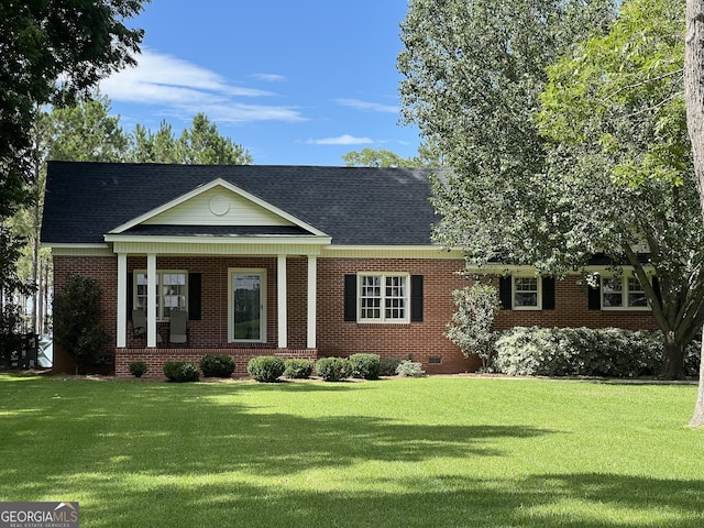 view of front facade with covered porch and a front lawn