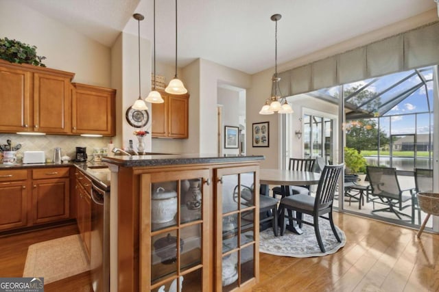 2491 Isles Of St Marys Way, Saint Marys, GA 31558 - kitchen with brown cabinetry, wood finished floors, and decorative backsplash
