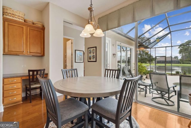 dining room featuring a wealth of natural light, wood-type flooring, and lofted ceiling